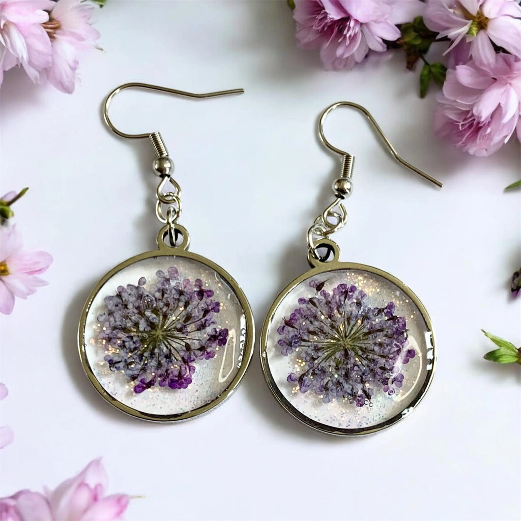 Delicate boucles d’oreilles circulaires fleur de givre avec fleurs violettes préservées en résine et bord doré