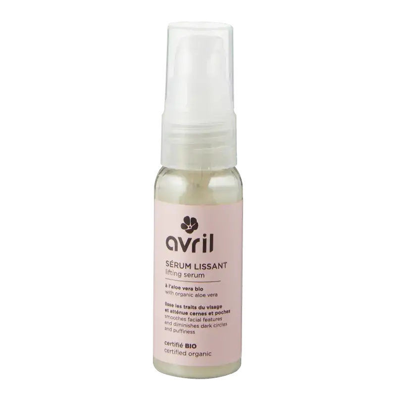 Un flacon en verre transparent avec un serum lifting avril à pompe blanche sur une étiquette rose pâle